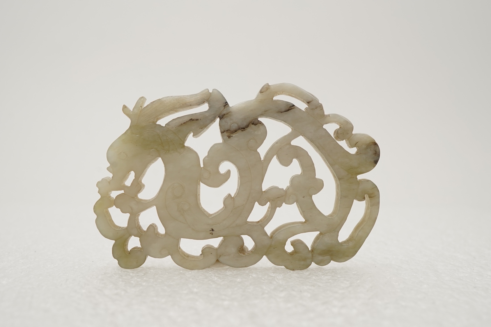 A Chinese white and grey mottled jade ‘chilong’ plaque, Ming dynasty